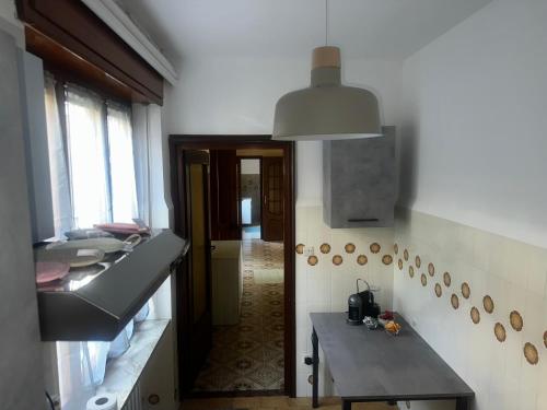 a kitchen with a sink and a table in it at La Villa in Pessinetto