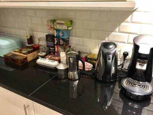 a black counter top with a coffee maker on it at Calm, green & birdsong near the city center in Brussels