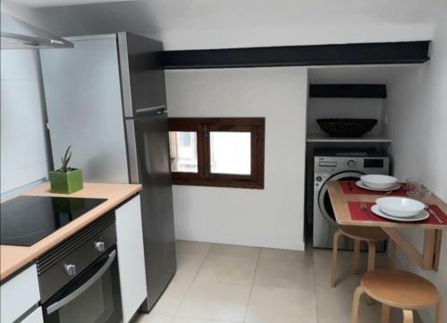 a small kitchen with a table and a counter top at Coro in Villaviciosa