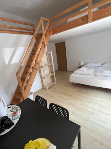 a room with a bed and a table with chairs at Lemonwood House in Postojna