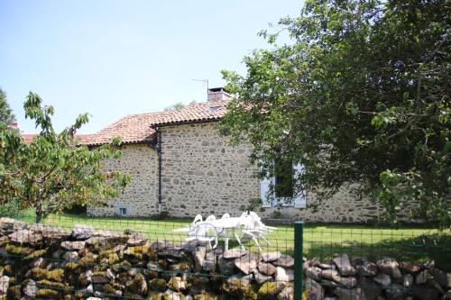 two white horses running in front of a building at Le Relais de Garabit in Anglards-de-Saint-Flour