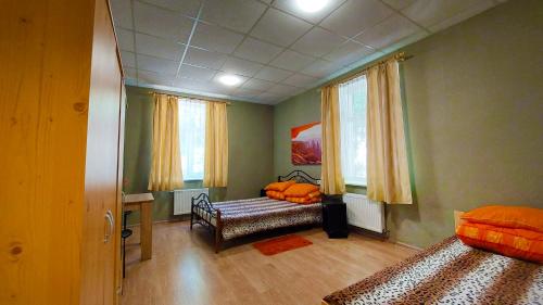 a bedroom with a bed and a bench in it at Happy Hostel in Rīga