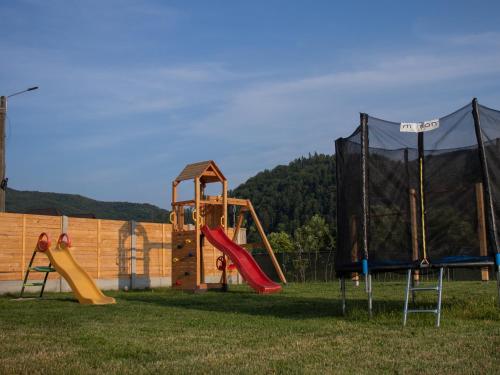 a playground with a slide and a play structure at DOM HILLS Bucovina in Gura Humorului