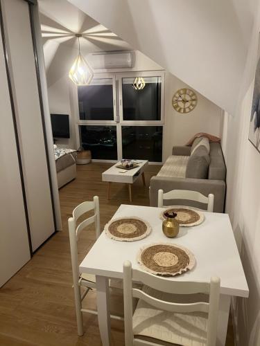 a living room with a table and chairs and a couch at Vista apart Pluzine in Plužine