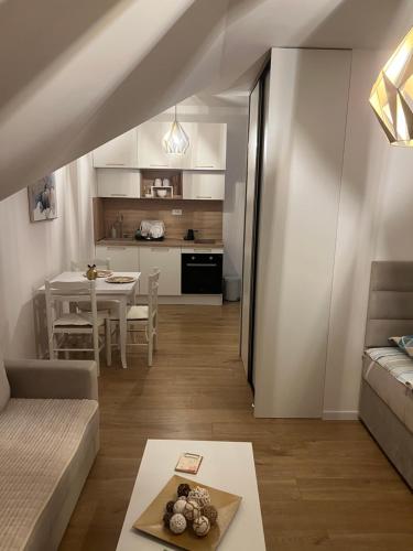 a living room with a couch and a table at Vista apart Pluzine in Plužine