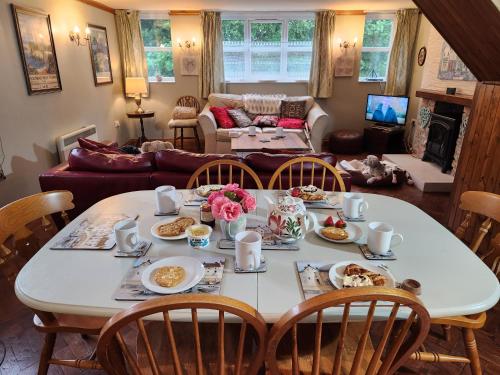 a table with food on it in a living room at The Old School Caeathro, Snowdon, Eryri and Yr Wydffa Cottages in Caernarfon