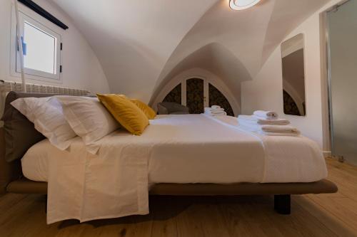 a bedroom with a large bed with towels on it at Suites7 in San Donato di Lecce
