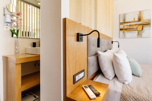 a bedroom with a bed and a desk with a remote control at Addimare Sea View Villa, and Events Venue in Alykes