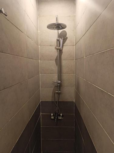 a shower with a shower head in a tiled bathroom at RED SEA HOTEL - فندق ريد سى in Suez