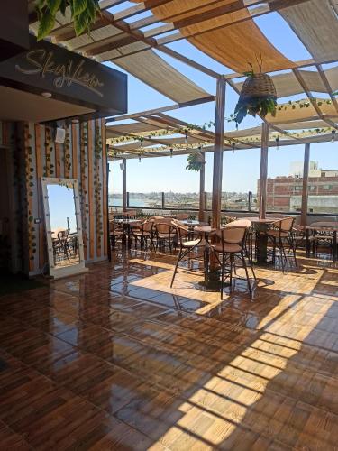 a patio with tables and chairs and a view of the city at RED SEA HOTEL - فندق ريد سى in Suez