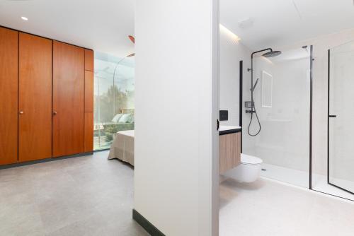 a bathroom with a shower and a toilet at Calatrava by Alma Suites in Valencia