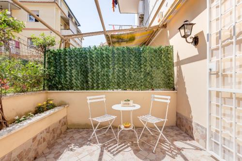 a small patio with a table and chairs on a balcony at Joker House Roma in 15 minuti Station Airport in Ciampino