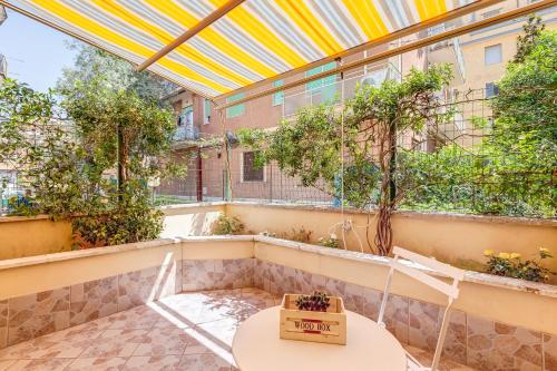 a balcony with a table and chairs and a building at Joker House Roma in 15 minuti Station Airport in Ciampino