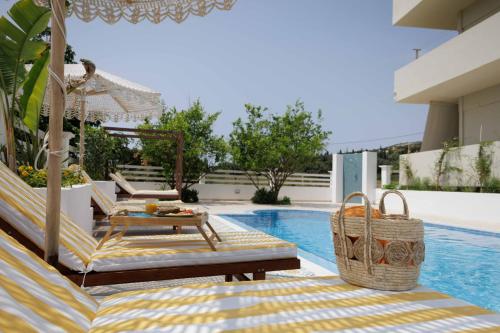 a villa with a swimming pool and a patio with chairs and a table at Maggana Residence in Minia