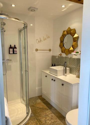 a bathroom with a shower and a sink and a mirror at Luxury & comfort in the Cotswolds in Banbury
