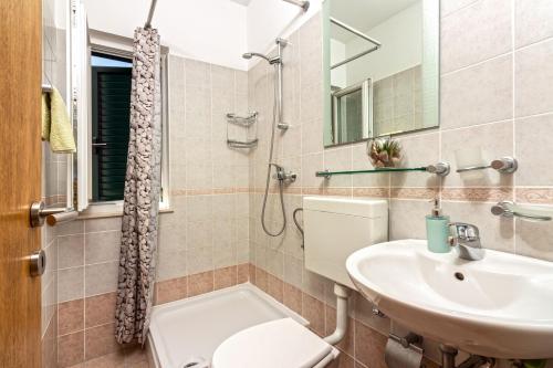 a bathroom with a toilet and a sink at Apartment Mandalina House in Stari Grad