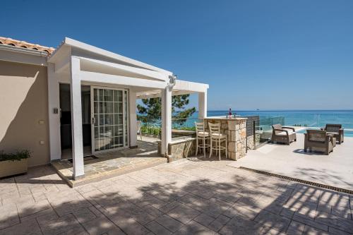 a patio with a view of the ocean at Addimare Sea View Villa, and Events Venue in Alykes