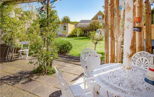 a white table and chairs on a patio at Stunning Home In Höganäs With Wifi in Höganäs