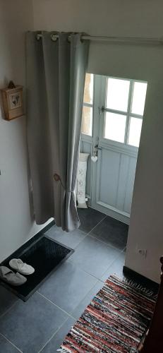 a bathroom with a shower and a door with a window at Au Cœur de Mauchat in Saint-Martin-de-Fressengeas