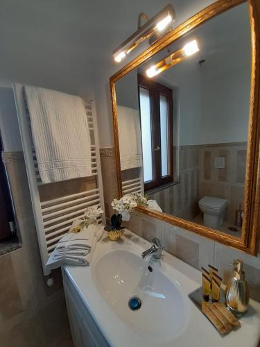 a bathroom with a sink and a mirror at La Vigna del Vento in Casola di Napoli