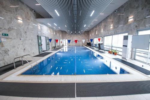 a large swimming pool in a large building at Chagala Residence Atyrau in Atyrau