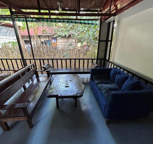 a living room with a couch and a table at Little John's Town Inn in Coron