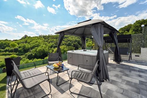 a gazebo on a patio with a table and chairs at AquaHaven With Private Pool And Wellness - Happy Rentals in Veliko Trgovišće