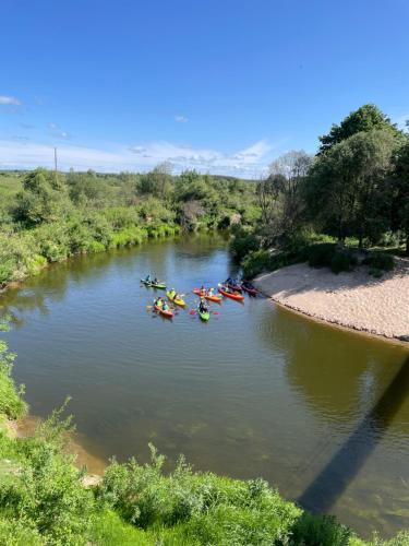 a group of people rafting down a river at Sodyba Pakrantė in Dituva