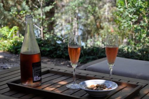 two glasses of wine and a bowl of food on a table at La cabaña del Burguillo in El Barraco