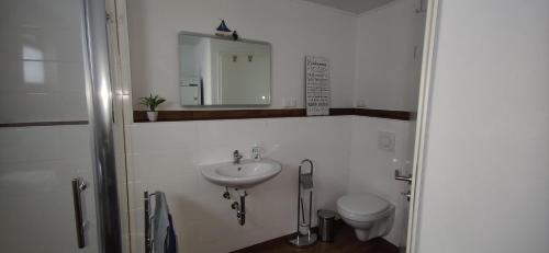 a bathroom with a sink and a toilet at Ferienhaus am Marktplatz in Oberheimbach