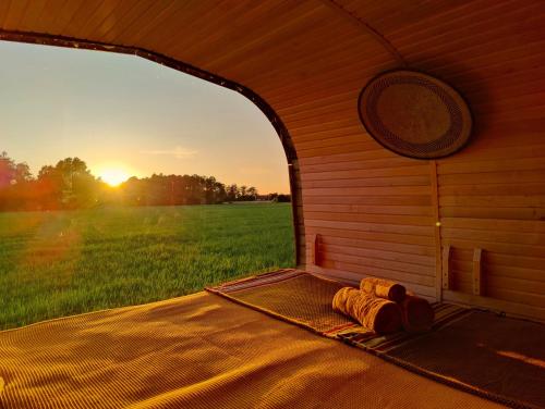 a inside of a dog house with a view of a field at Under Canvas Bornholm in Østermarie