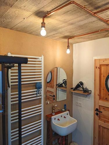 a bathroom with a sink and a mirror at Nautilus in Reinsfeld