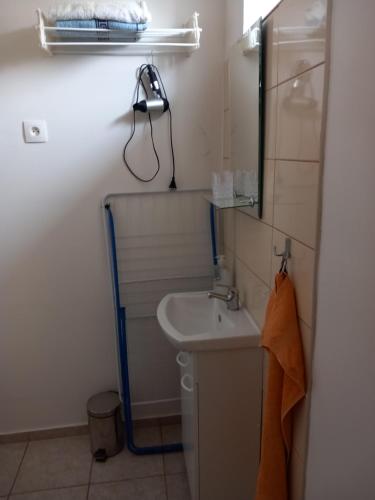 a bathroom with a sink and a mirror at Apartman Lotus -obnovená in Veľký Meder