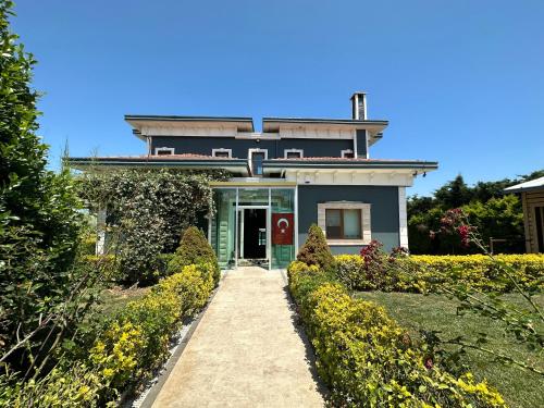 a house with a pathway leading to the front door at TURAN VİLLA in Arnavutköy