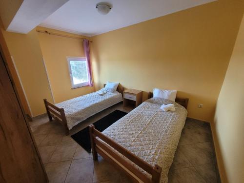 a room with two beds and a window at Apartments Dragon in Umag