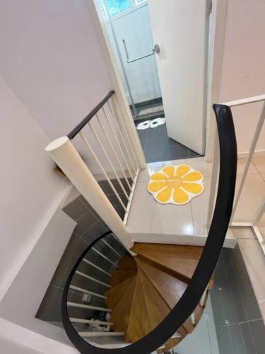 a spiral staircase with a chair with a flower on it at The Van Gogh Loft at Selesa Hillhomes in Bukit Tinggi