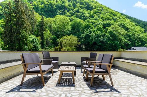 a group of chairs and a table on a patio at Cedrus Boutique in Braşov