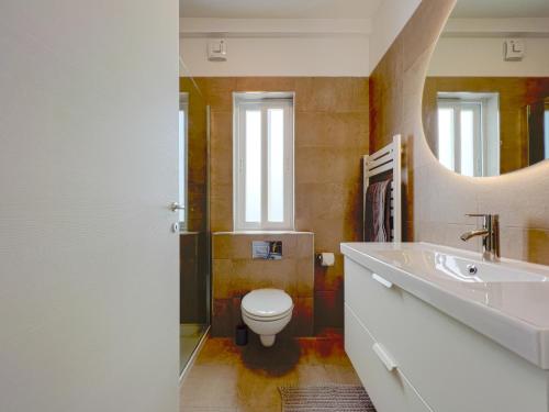 a bathroom with a toilet and a sink and a mirror at 21 Townhouse in St Julians in Paceville