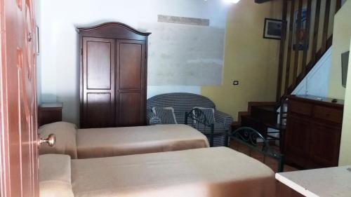 a room with two beds and a stair case at Hotel Tenuta San Francesco in Barletta