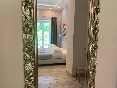 a mirror on a wall in a room with a bed at ROYAL GARDENS in Caserta
