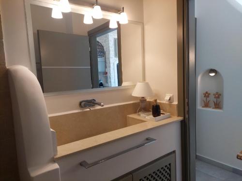 a bathroom with a sink and a mirror at Villa Kairos- Aegean Sea in Masouri