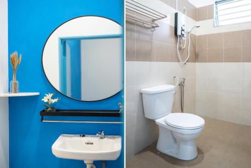 a bathroom with a toilet and a sink and a mirror at No 19 Studio Homestay (Semi-D), Port Dickson (up to 13 pax) in Port Dickson