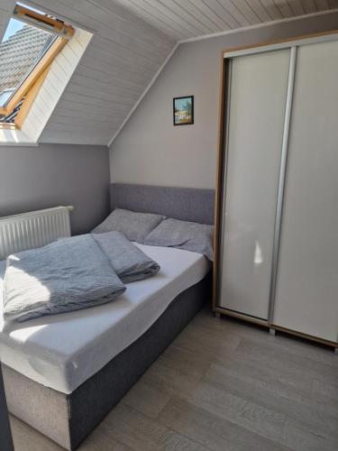 a small bedroom with a bed with a window at DOM GOŚCINNY ANNA in Niechorze