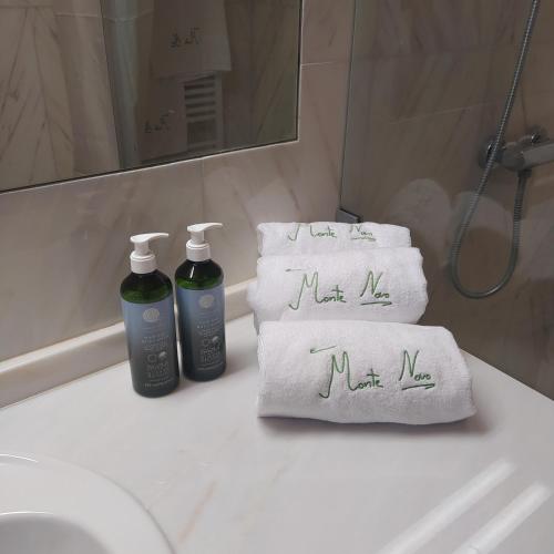 a bathroom with two towels with the words new me on them at Casa do Forno Évora retreat in Redondo