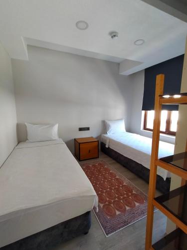 a bedroom with two beds and a ladder at Gala Otel Edirne in Edirne