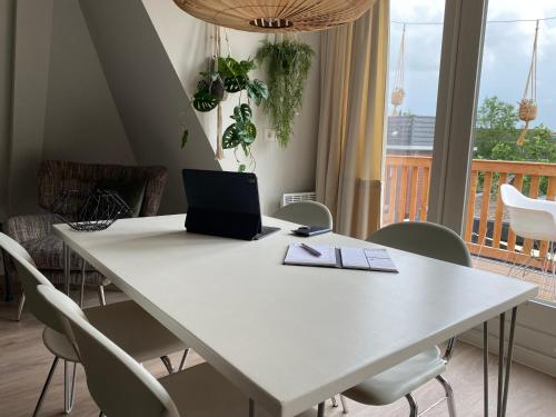 a white table with a laptop on top of it at Suite Spot Houten in Houten