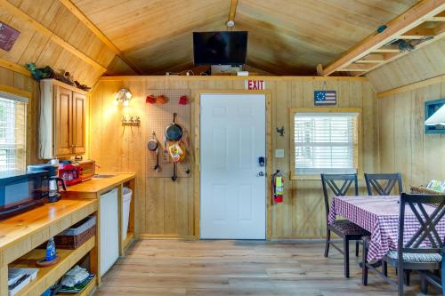 a kitchen with a table and a white door at Lake Fork Studio Cabin with Dock and Boat Ramp! in Emory