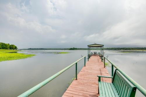a wooden dock with a gazebo on a lake at Lake Fork Studio Cabin with Dock and Boat Ramp! in Emory