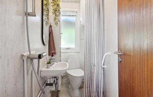 uma casa de banho com um lavatório, um WC e uma janela. em Lovely Home In Brkop With Kitchen em Børkop