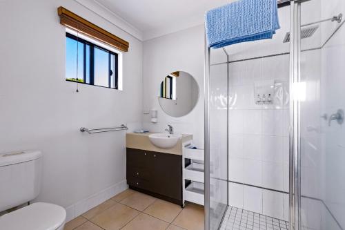 a bathroom with a shower and a toilet and a sink at Zion Escapes Retreat on Pease, City Edge Family Apartment in Westcourt
